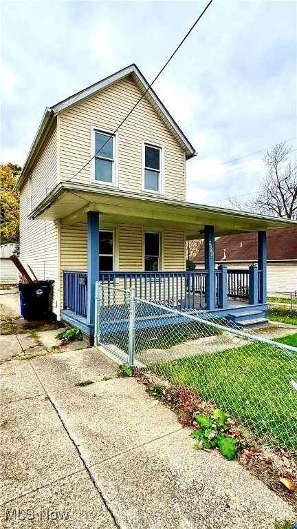 Traditional home featuring covered porch