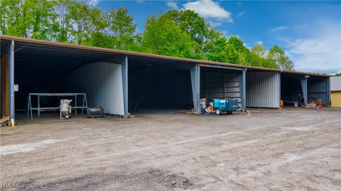 View of parking / parking lot with a pole building