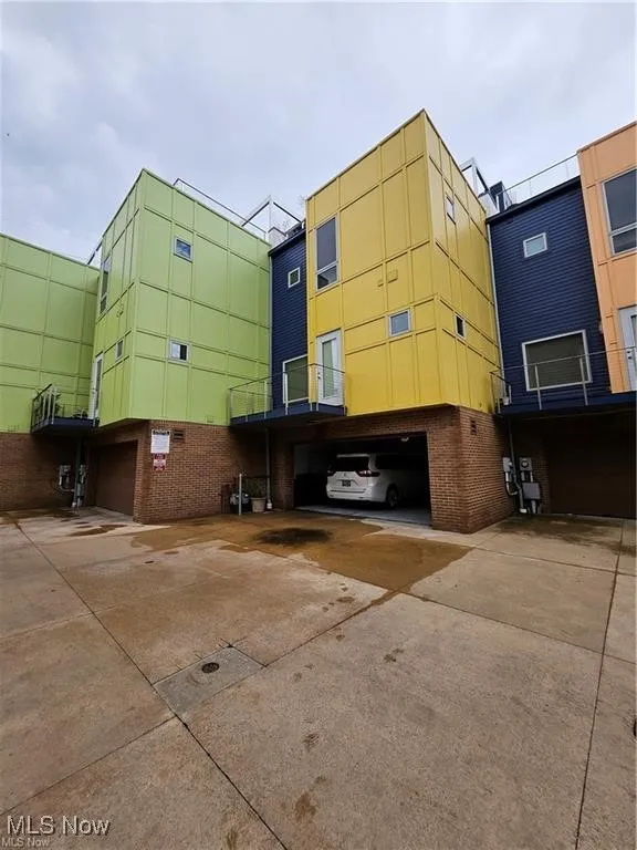 View of property featuring an attached garage and driveway
