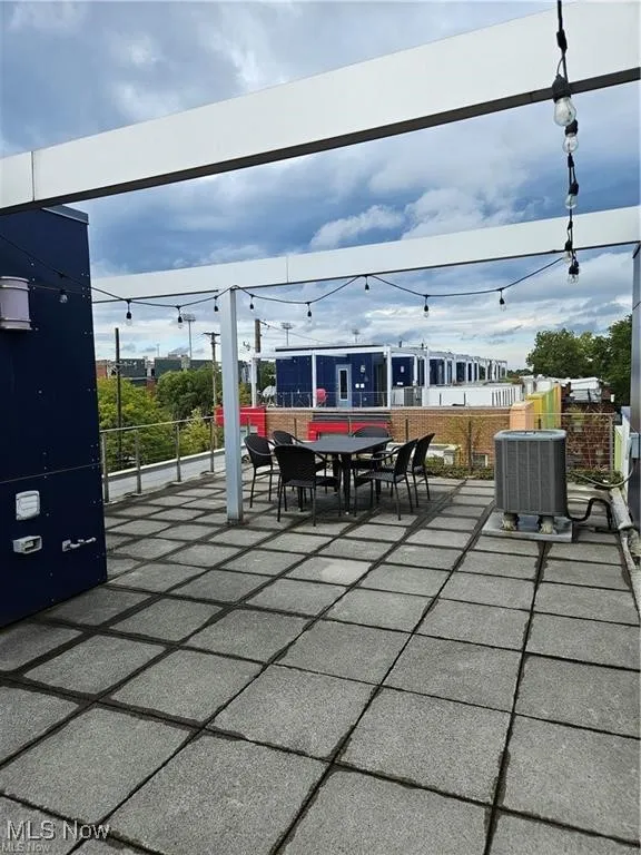 View of patio with central air condition unit and outdoor dining space