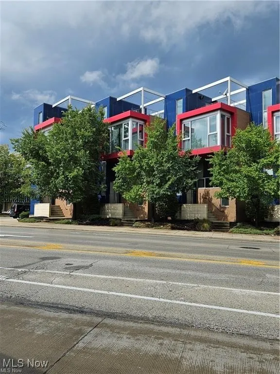 View of asphalt street featuring curbs and sidewalks