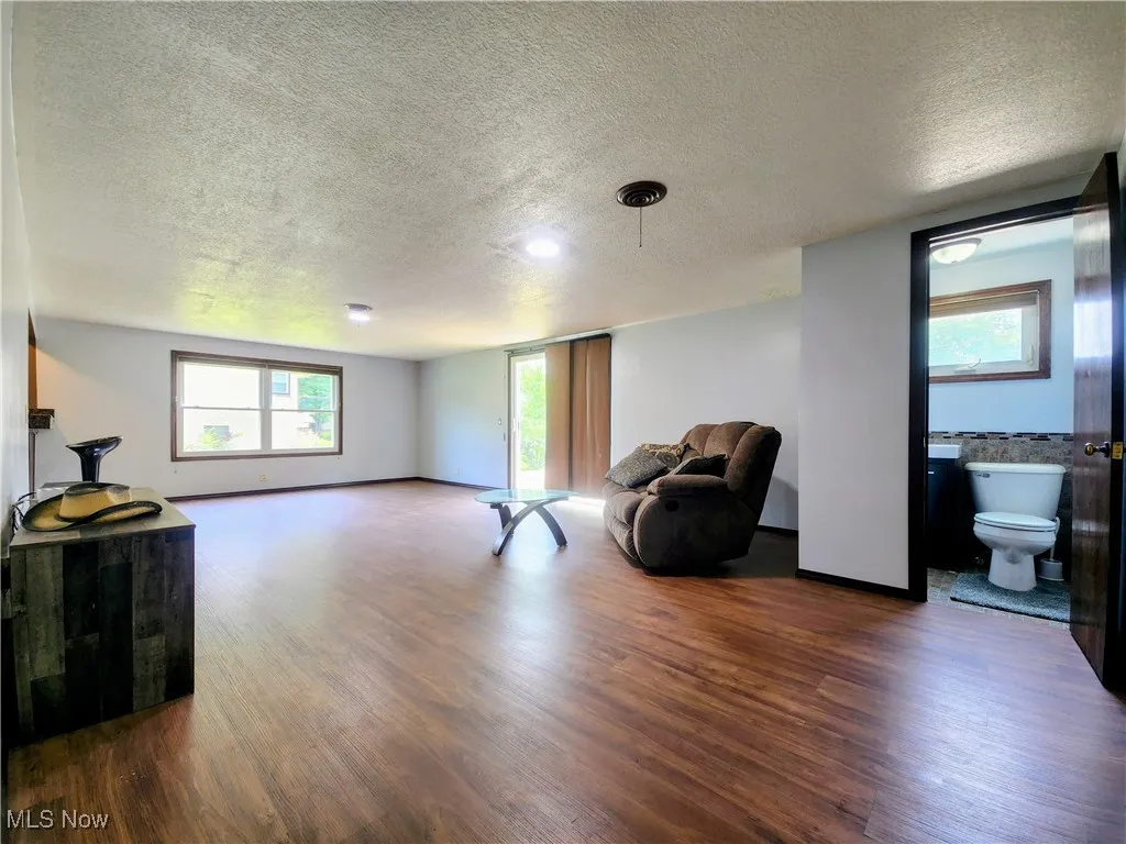 Sitting room featuring a textured ceiling and wood finished floors
