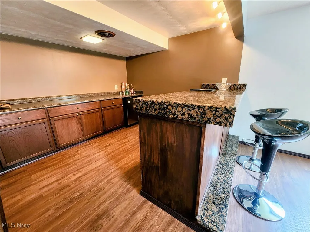 Kitchen featuring light wood-style flooring and a peninsula