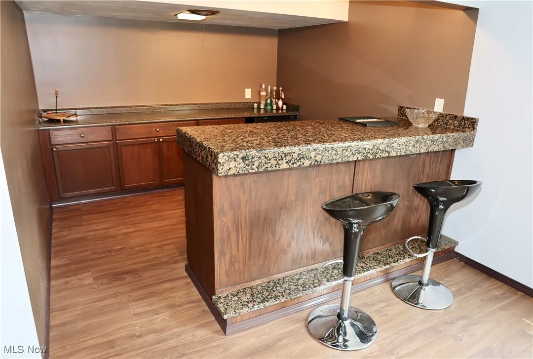 Indoor bar with light wood-style floors and baseboards