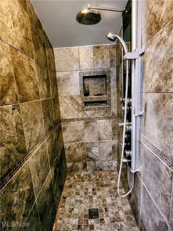 Bathroom featuring tiled shower