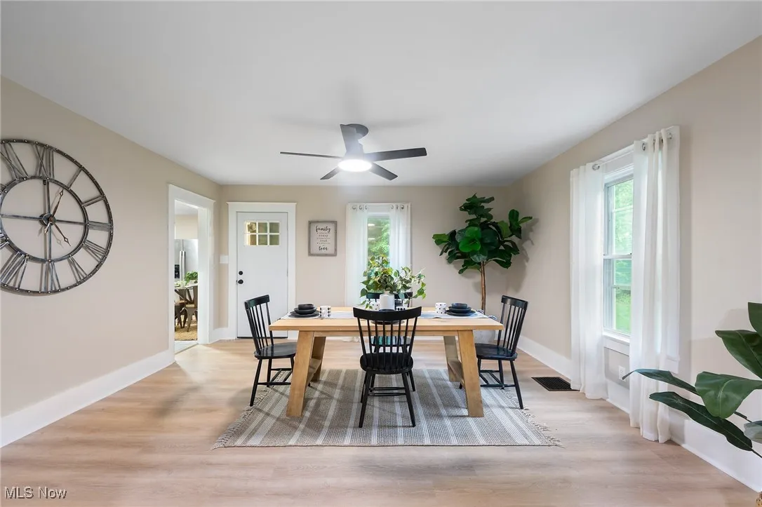 Dining area featuring light wood-style flooring, healthy amount of natural light, and ceiling fan