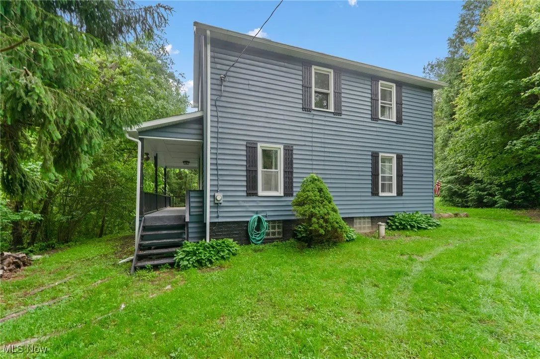 Back of property featuring a lawn