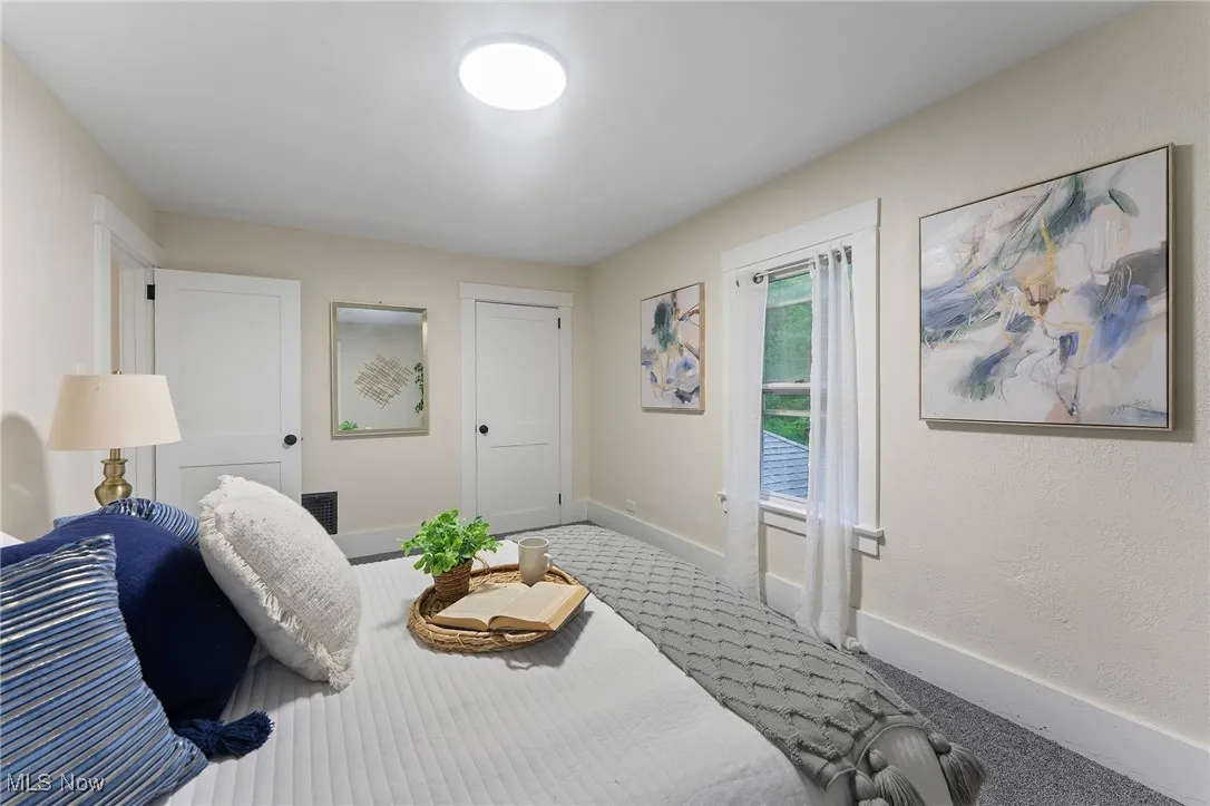 Bedroom with baseboards and carpet flooring