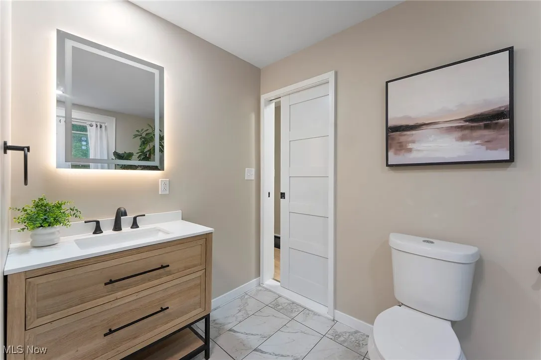 Bathroom featuring tile floors and vanity