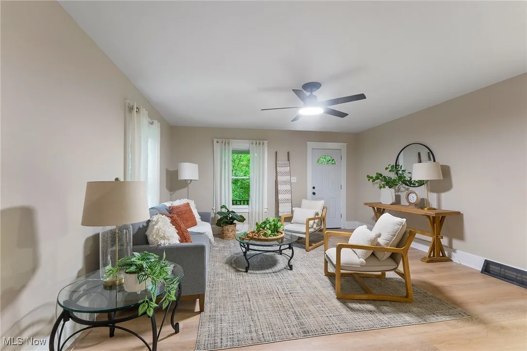 Living room with a ceiling fan and wood finished floors