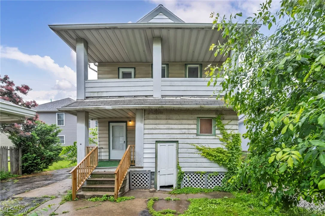View of front facade featuring a balcony and covered porch