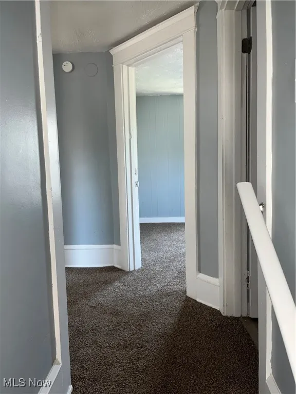 Hall with carpet and baseboards