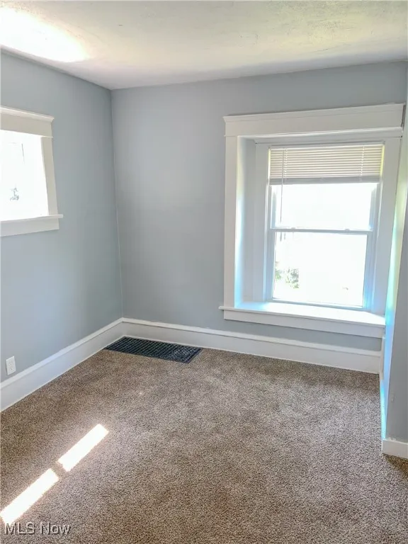 Spare room with carpet floors and baseboards