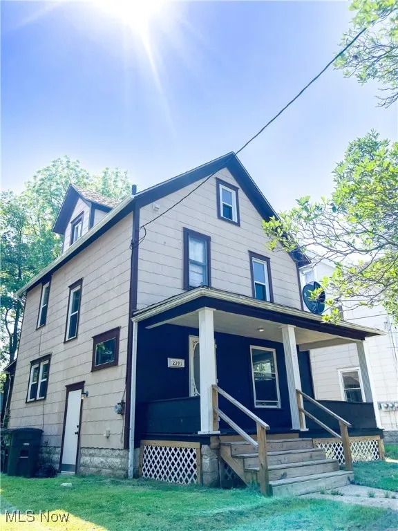 View of front of house featuring a porch and a front lawn