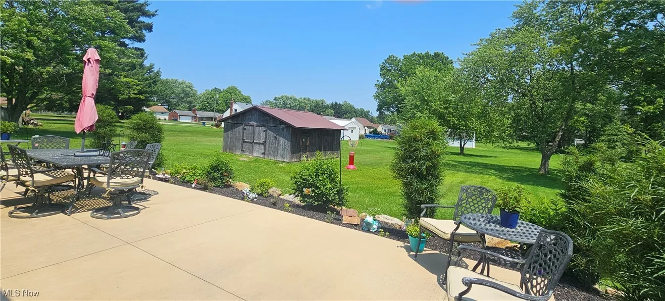 View of patio / terrace with outdoor dining area and a storage unit