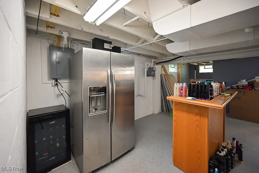 Kitchen featuring stainless steel fridge and electric panel