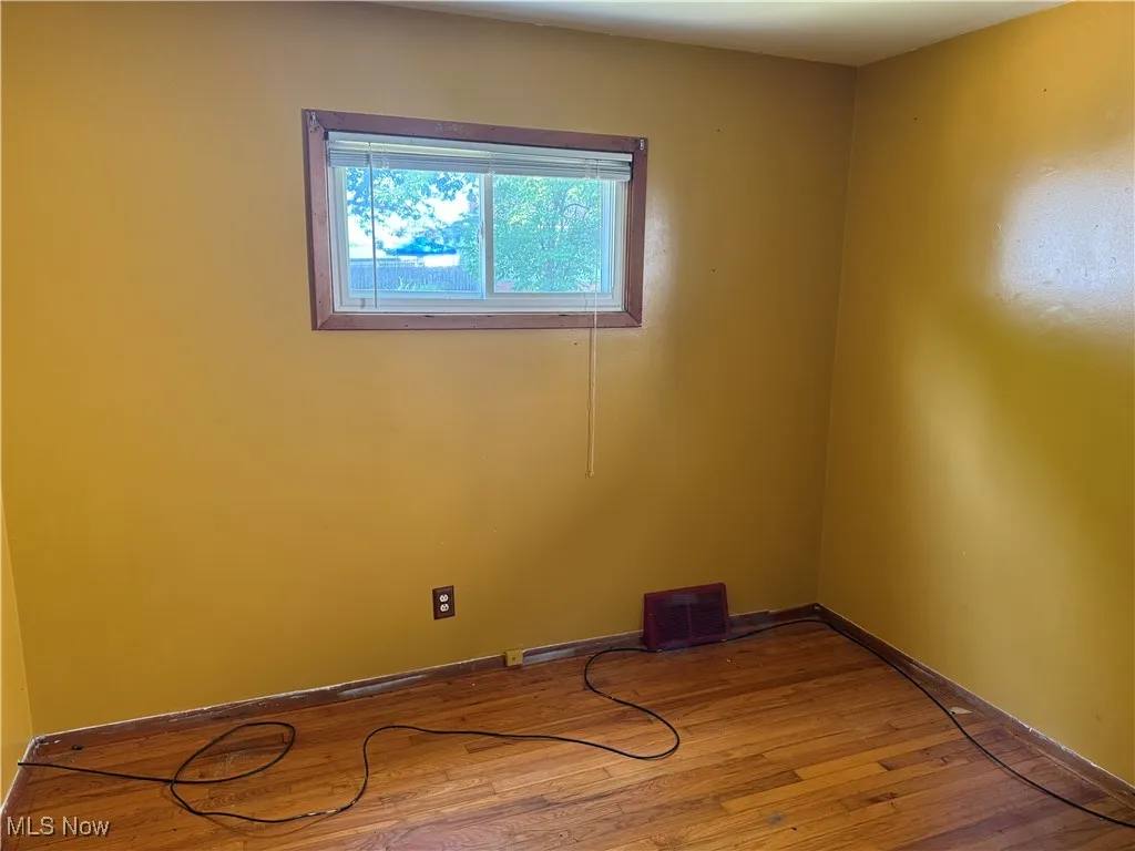 Empty room with wood finished floors and baseboards