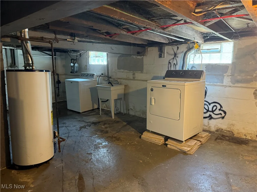 Basement featuring gas water heater and washer and dryer