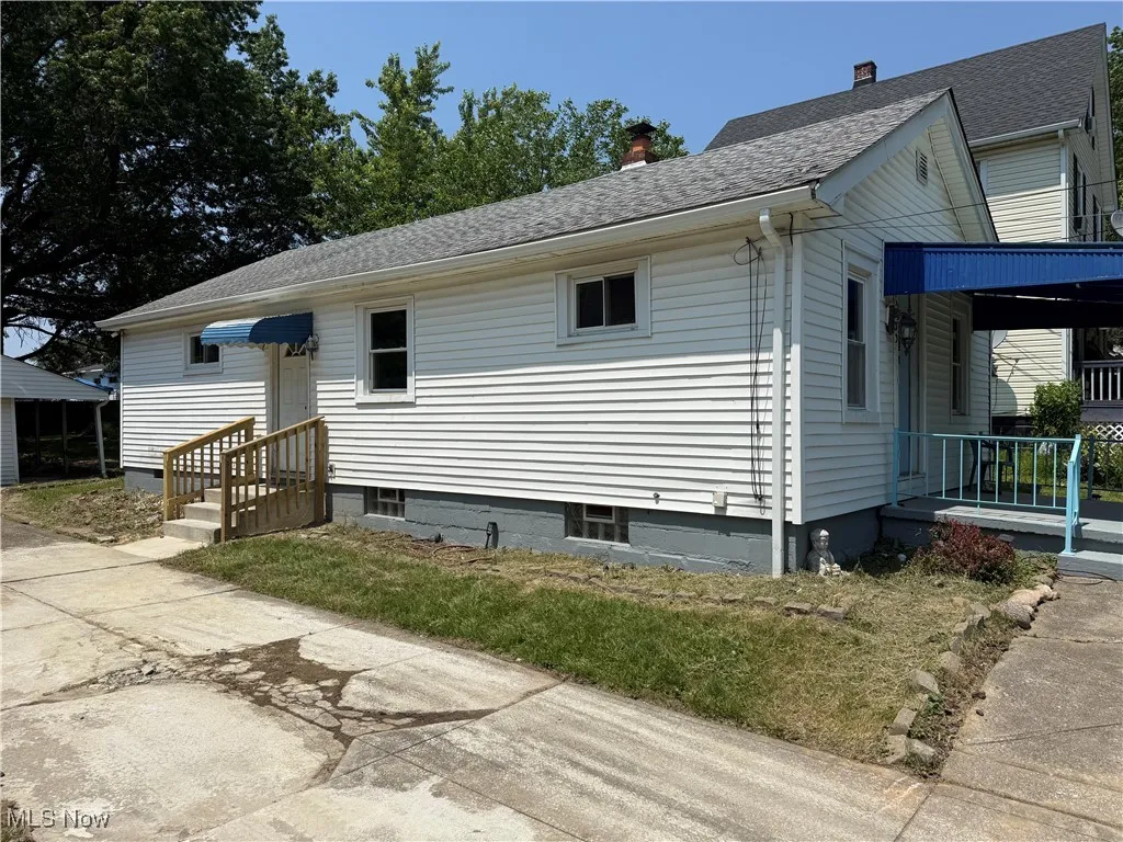 View of property exterior featuring a chimney and roof with shingles