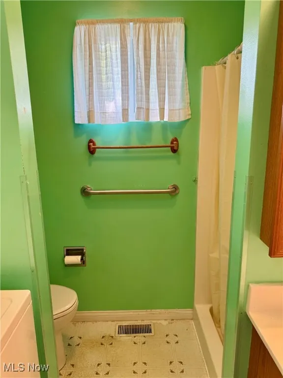 Full bathroom with vanity and a shower with shower curtain