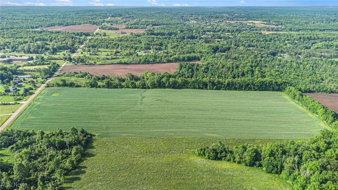 Aerial view of property's location with rural landscape and a forest