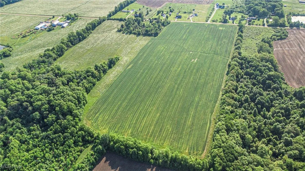 Aerial overview of property's location featuring rural landscape and extensive farmland