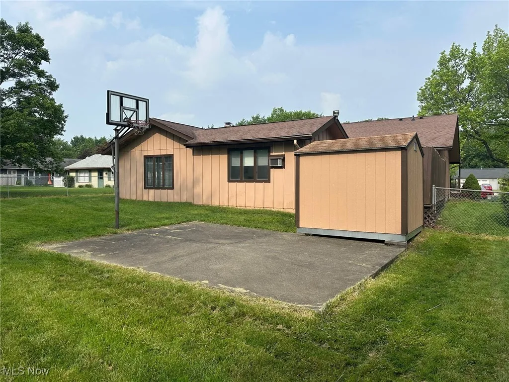 View of backyard and basketball court.