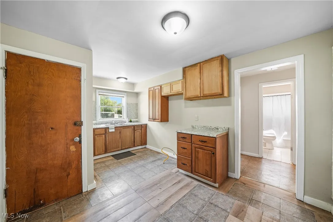 Kitchen with baseboards and brown cabinetry