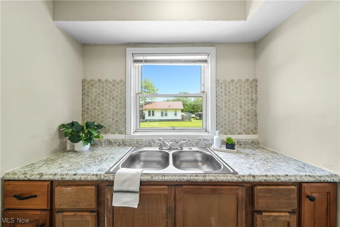 Kitchen featuring light countertops and brown cabinets