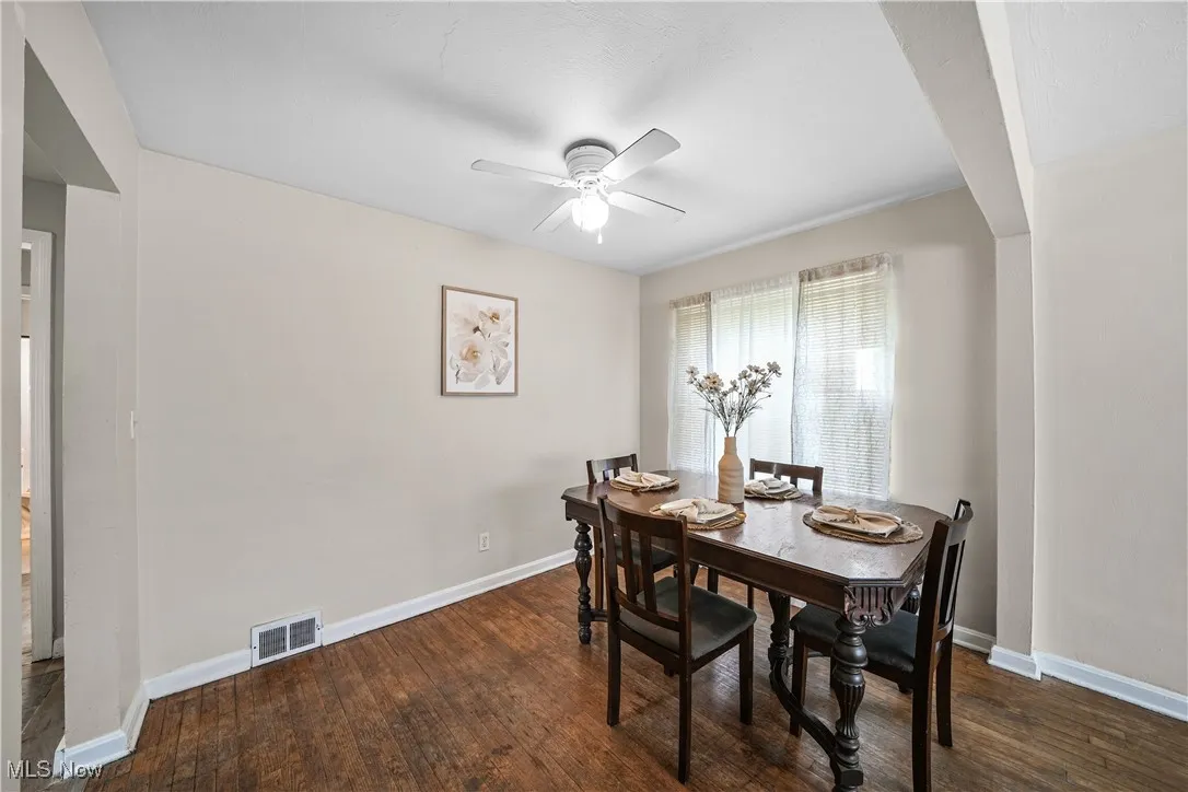 Dining space with a ceiling fan and hardwood / wood-style flooring