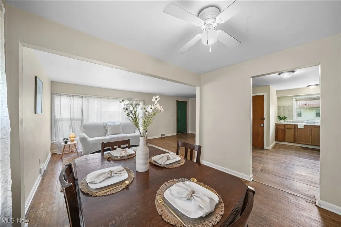 Dining space with wood finished floors, healthy amount of natural light, and a ceiling fan