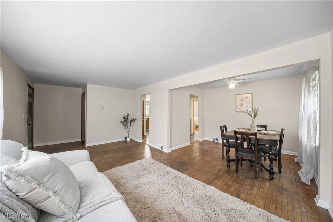 Living area featuring wood-type flooring and a ceiling fan