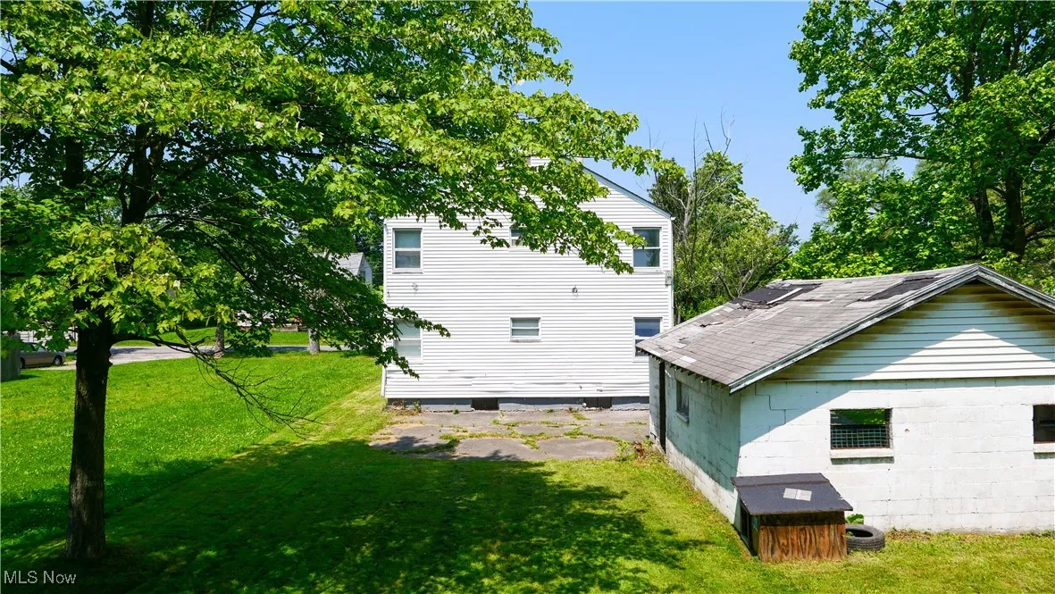 View of side of home featuring a lawn