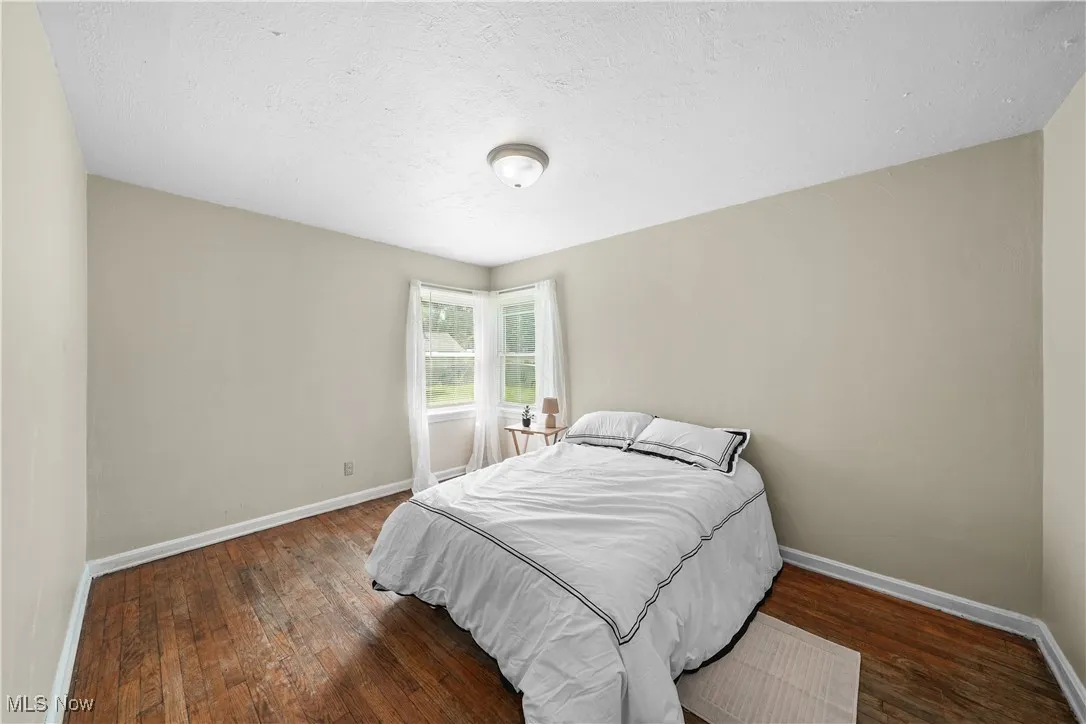 Bedroom featuring hardwood / wood-style floors and a textured ceiling