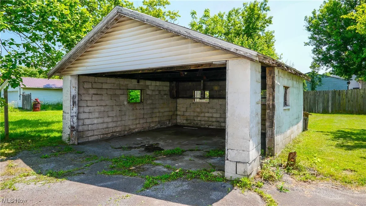 Garage with a detached carport and driveway
