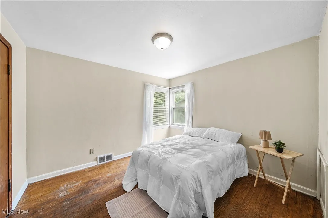 Bedroom with hardwood / wood-style flooring