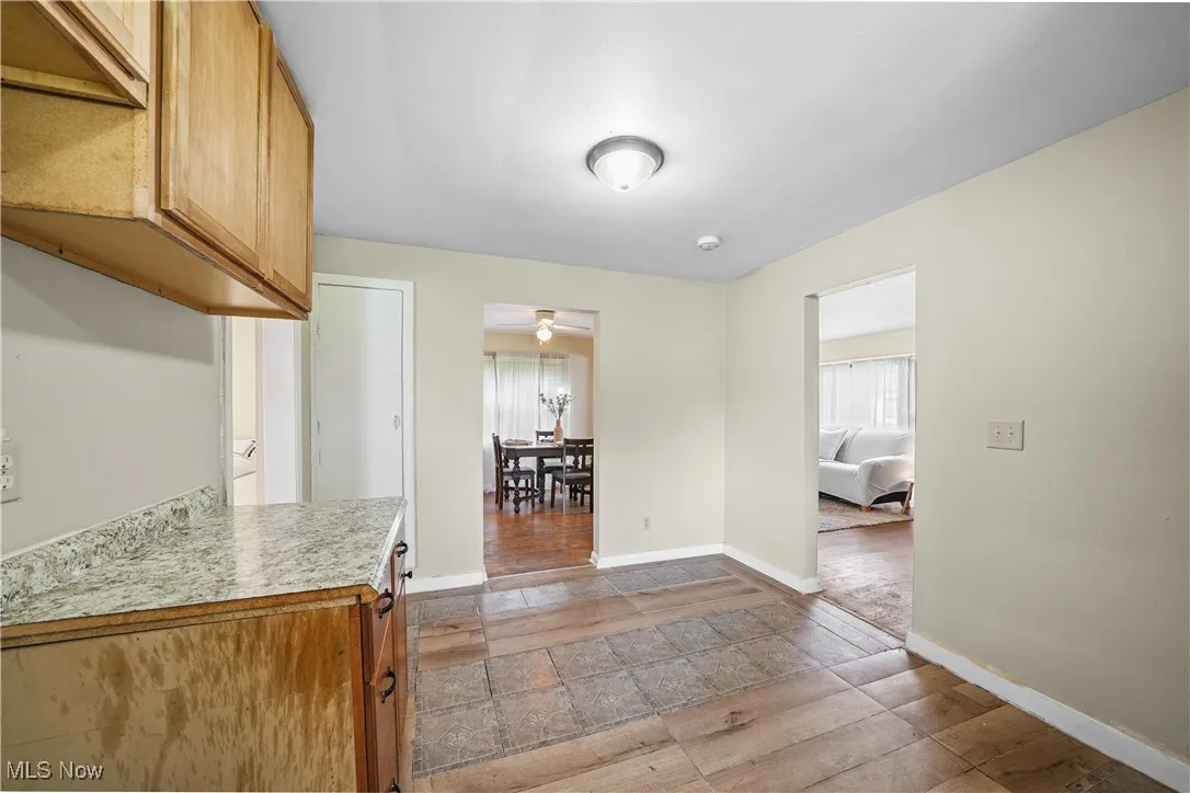 Kitchen featuring light countertops, a ceiling fan, and light wood-style floors