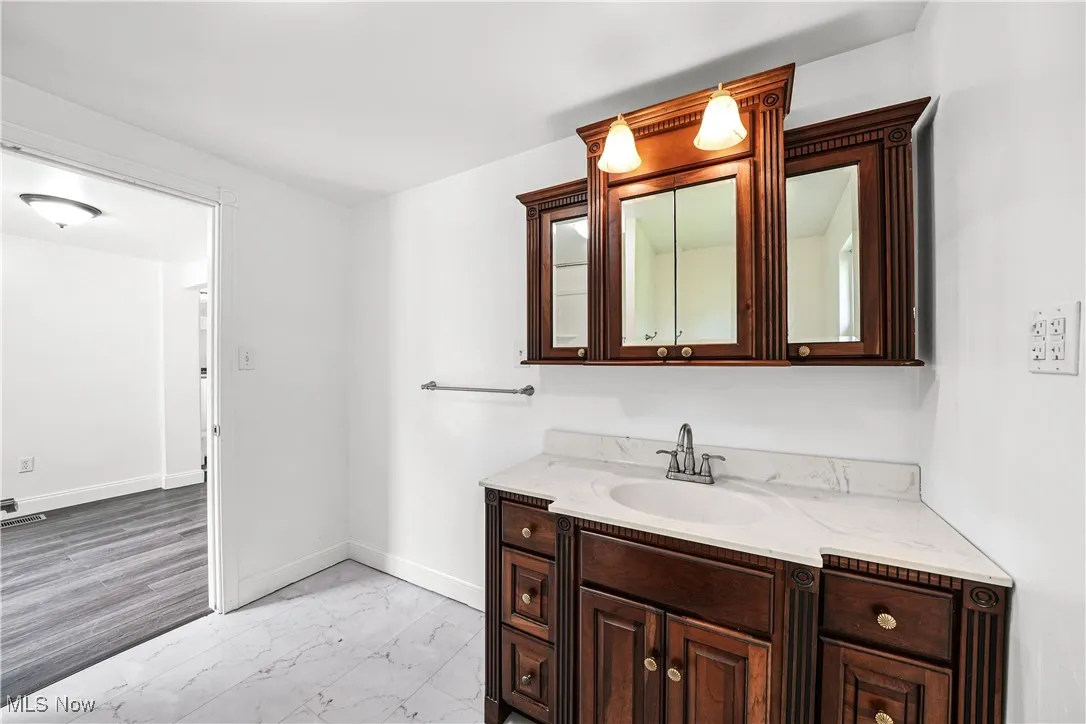 Bathroom with marble look tiles and vanity