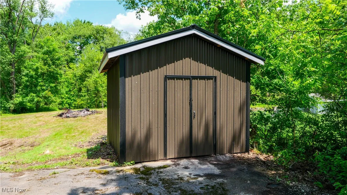View of shed featuring a wooded view