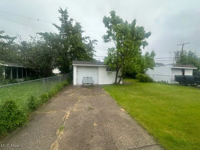 Detached garage featuring driveway