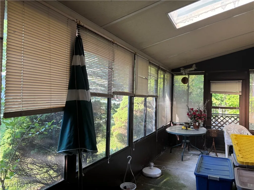 Sunroom / solarium with a skylight and lofted ceiling