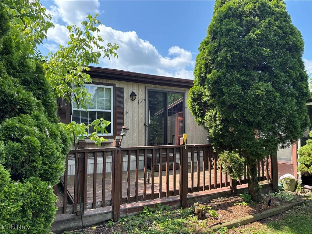 View of front of home with a wooden deck