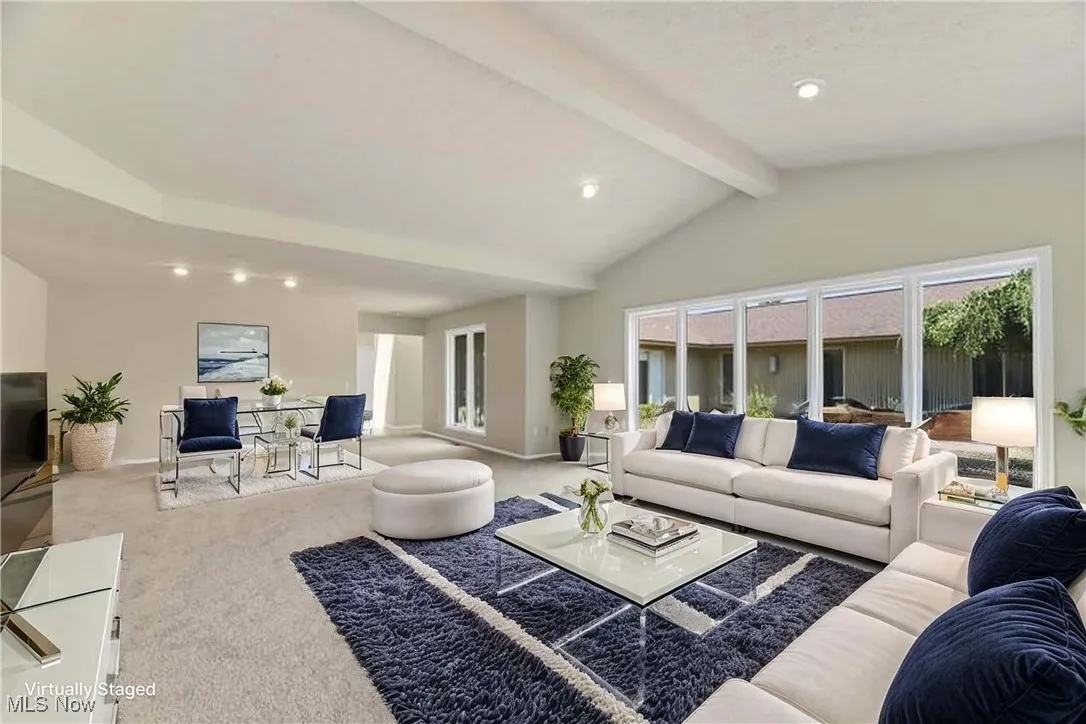 Living room featuring carpet floors, healthy amount of natural light, and recessed lighting