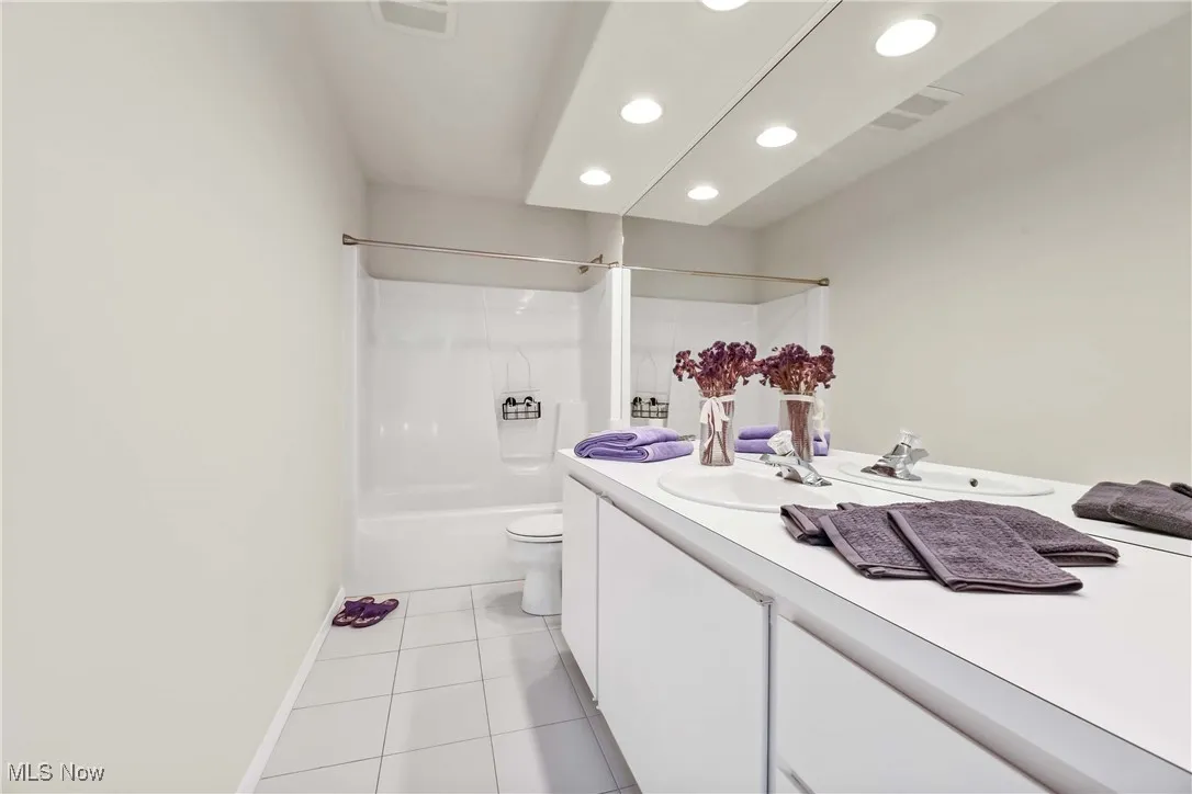 Full bathroom with recessed lighting, vanity, tile patterned floors, and  shower combination