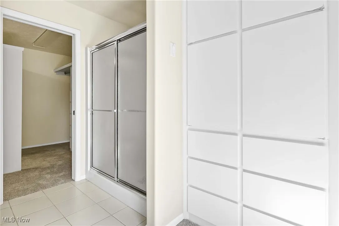 Full primary bathroom featuring a tub and shower