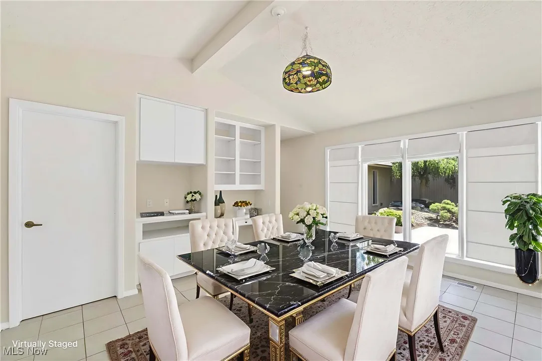 Dining area featuring light tile patterned floors