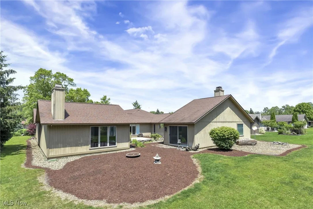 Rear view of house with a yard
