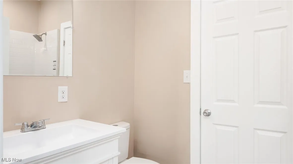 Bathroom featuring vanity and a tile shower