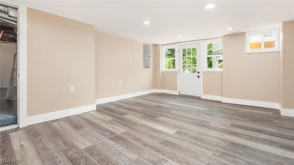 Empty room featuring wood finished floors, recessed lighting, and electric panel