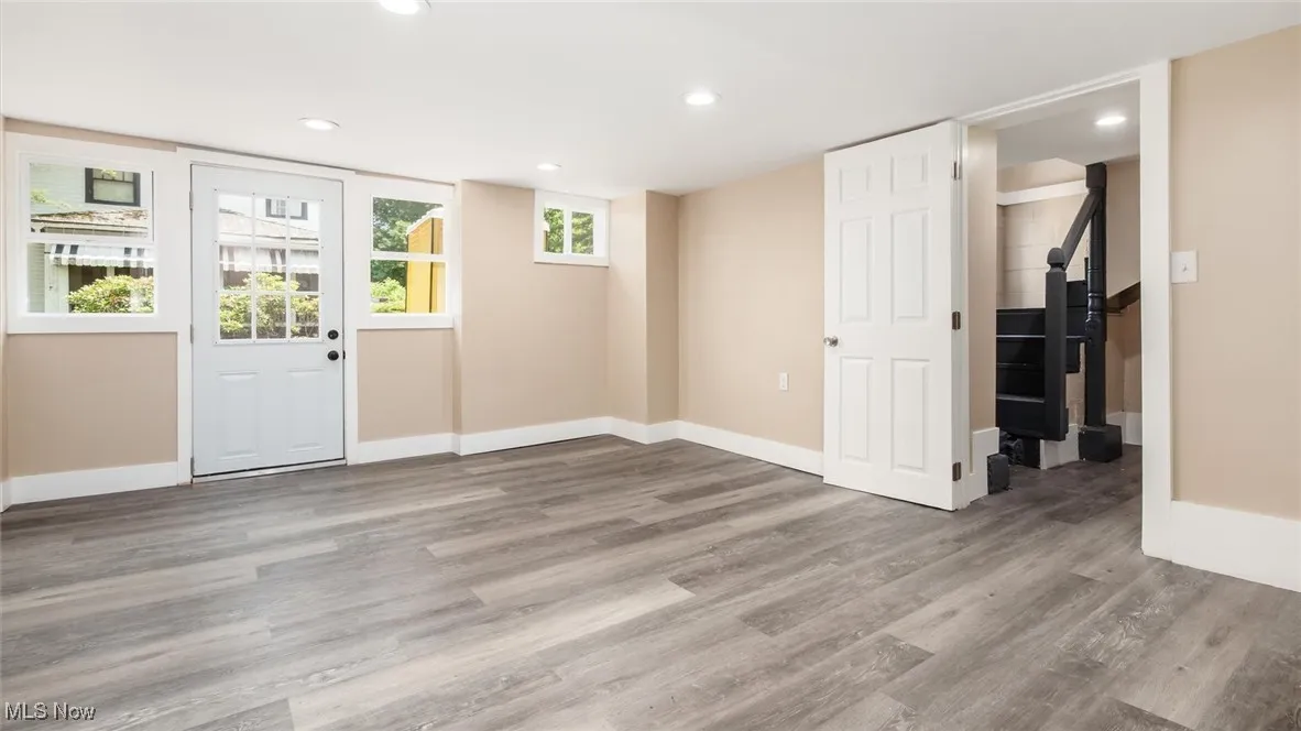 Entryway with wood finished floors and recessed lighting